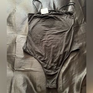 Black tank body suit .